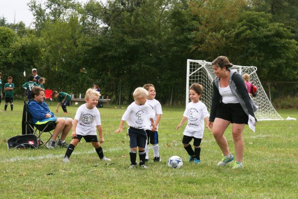 Emily coaches her team on how to do a drill